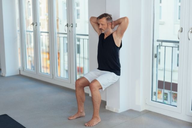 6 Wall Exercises That Work Wall Sit with Arm Circles
